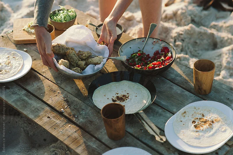Family-style meal shared around an outdoor table